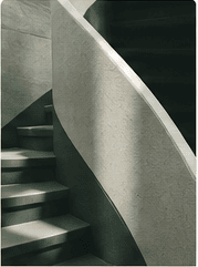 Concrete stairs beside a curved architectural wall